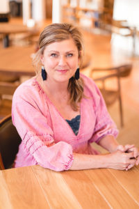 Woman seated at a table, intently listening
